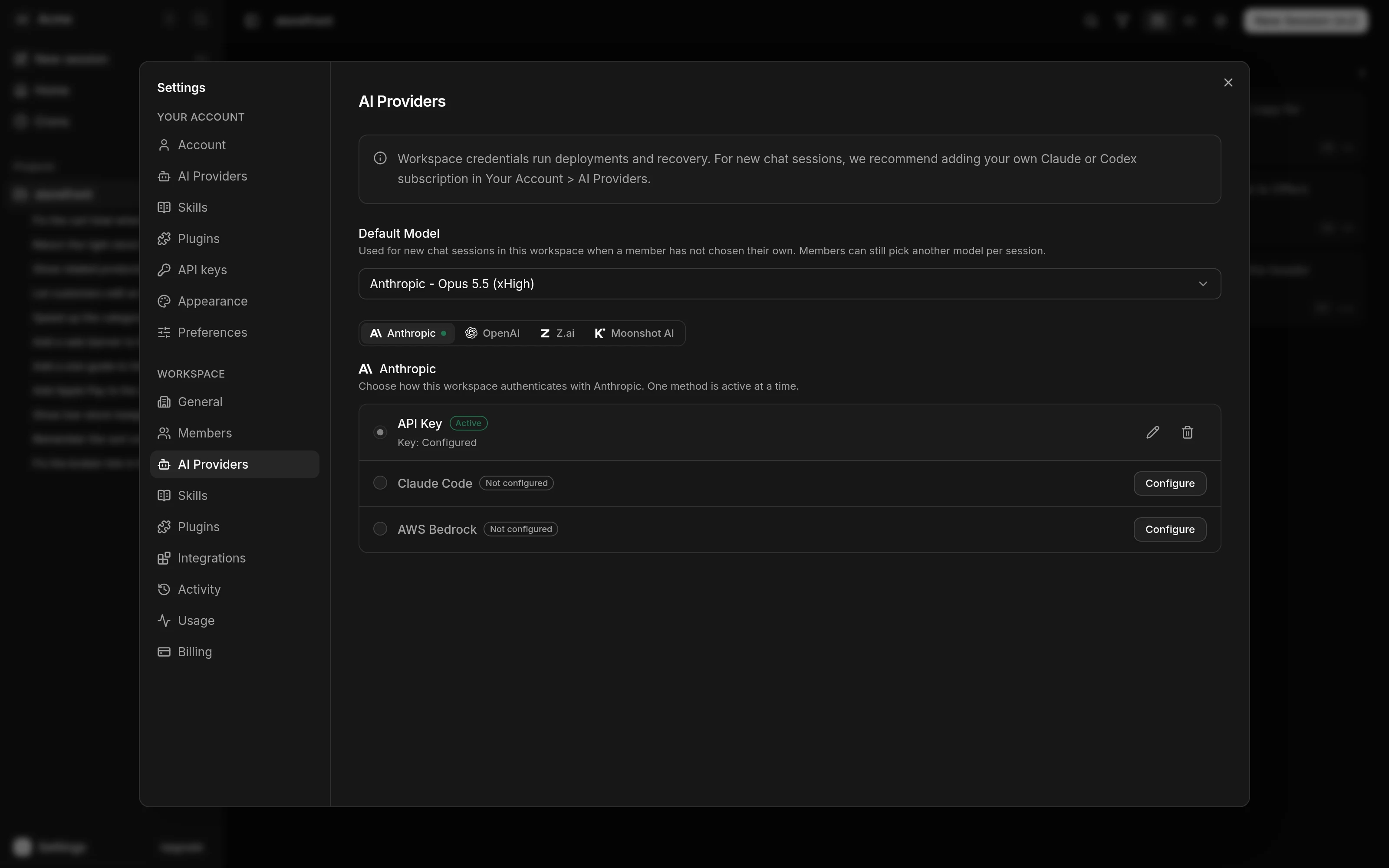 The workspace AI Providers section of Settings, as an admin sees it. A note says workspace credentials run deployments and recovery. Default Model reads Anthropic - Opus 5.5 (xHigh). Below are tabs for Anthropic, OpenAI, Z.ai and Moonshot AI, open on Anthropic. There, API Key is marked Active with Key: Configured, and Claude Code and AWS Bedrock are marked Not configured with a Configure button each.
